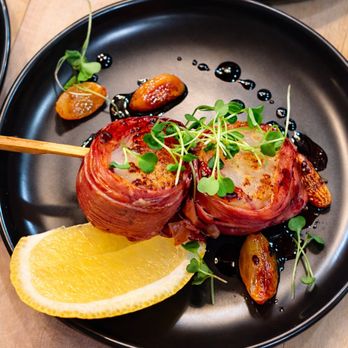 Thyme & Travel Private Chef - Prosciutto-wrapped sea scallops finished with a rich port reduction, roasted garlic and fresh microgreens. - Personal Chefs Near Me - Flagstaff, Arizona Thyme & Travel Private Chef - Prosciutto-wrapped sea scallops finished with a rich port reduction, roasted garlic and fresh microgreens. - Personal Chefs Near Me - Flagstaff, Arizona