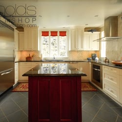 Reynolds Cabinet Shop - Stratford painted door on outside, dark cherry wood island, granite countertop