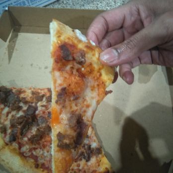 Domino's Pizza - a hand holding a slice of pizza - Pizza Near Me - Arlington, Texas Domino's Pizza - a hand holding a slice of pizza - Pizza Near Me - Arlington, Texas