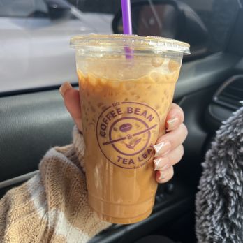 The Coffee Bean & Tea Leaf - a hand holding a cup of iced coffee - Coffee & Tea Near Me - Riverside, California The Coffee Bean & Tea Leaf - a hand holding a cup of iced coffee - Coffee & Tea Near Me - Riverside, California