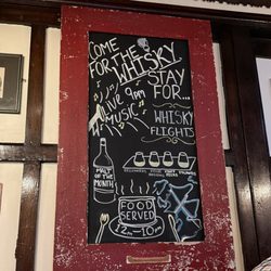 Sign outside the men's room door.