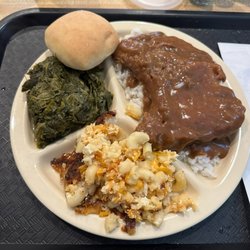 Milestone Soul Food - My favorite! Smothered pork chop over rice, collard greens and Mac and cheese.