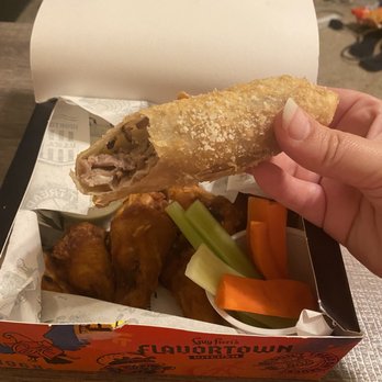 Guy Fieri's Flavortown Kitchen - Philly cheesesteak egg roll (comes with cheese dip) and Buffalo wings (mild) - Food Delivery Services Near Me Guy Fieri's Flavortown Kitchen - Philly cheesesteak egg roll (comes with cheese dip) and Buffalo wings (mild) - Food Delivery Services Near Me
