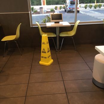 McDonald's - a yellow caution cone in front of a window - Coffee & Tea Near Me - Hudson, Florida