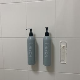 Broken toiletry dispenser. Maintenance came and fixed it... it fell again, photo taken after it fell Broken toiletry dispenser. Maintenance came and fixed it... it fell again, photo taken after it fell