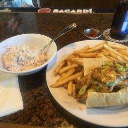 Catfish po-boy and a bowl of coleslaw. Catfish po-boy and a bowl of coleslaw.