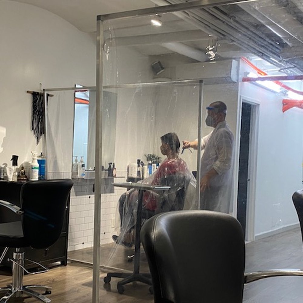 Hairstylists wear face masks and shield and protective rob, client wear face masks and protective cover, all stations have partisans Hairstylists wear face masks and shield and protective rob, client wear face masks and protective cover, all stations have partisans