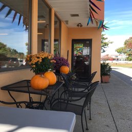 a table and chairs outside of a restaurant a table and chairs outside of a restaurant