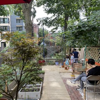 Cicada Coffee Bar - Outdoor seating in the garden area - Vietnamese Near Me - Cambridge, Massachusetts Cicada Coffee Bar - Outdoor seating in the garden area - Vietnamese Near Me - Cambridge, Massachusetts