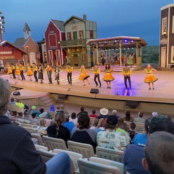 Medora Musical - a group of dancers performing on stage - Restaurants Near Me