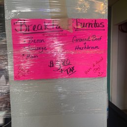 a pink sign on a refrigerator