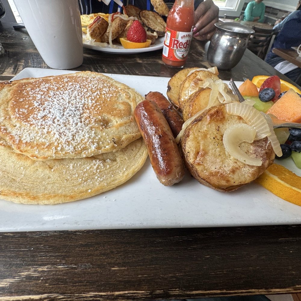 Pancakes, sausage links, fresh fruit and breakfast potatoes