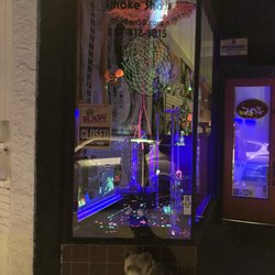 Dragons Den Smoke Shop - My dog champ out front, after hours, checking out all the super cool lighting