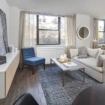 River North Park - Living room with sectional sofa and blue accent chair - Apartments Near Me - Chicago, Illinois River North Park - Living room with sectional sofa and blue accent chair - Apartments Near Me - Chicago, Illinois