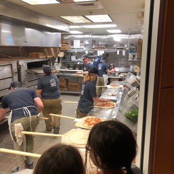 Dewey's Pizza - Pizza making time. Memories made at Dewey's. My daughter and friend have been watching pizzas being made for 15 minutes. - Pizza Near Me - Ellisville, Missouri