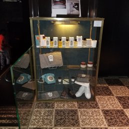 Cabinet In lobby of Les Bains signature items they have for sale.