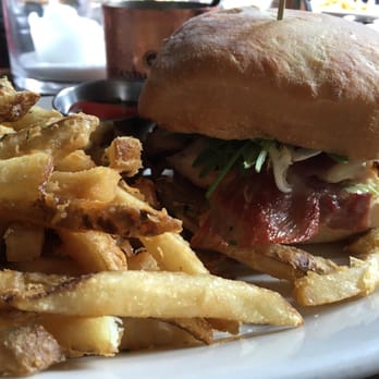 Lumberyard - $12 lunch menu item: pesto chicken sandwich has prosciutto and avocado on it and fries. Delicious! - New American Near Me - Laguna Beach, California
