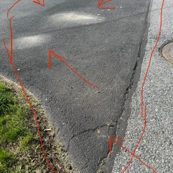 Richard's Paving - Brown spots are constant puddles. Huge crack in the apron part. That whole square section is crumbling.