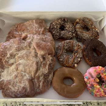 Donut King - Two apple fritters, a KitKat donut, two snickers donuts, a grasshopper (mint and chocolate) a maple and a fruit loop donut. - Donuts Near Me - Winter Park, Florida