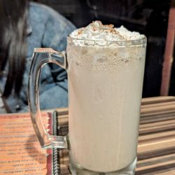 Licuado de plátano (banana smoothie). Topped with whipped cream & cinnamon