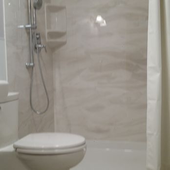 Bath Techs - a toilet and shower in a bathroom - General Contractors Near Me Bath Techs - a toilet and shower in a bathroom - General Contractors Near Me