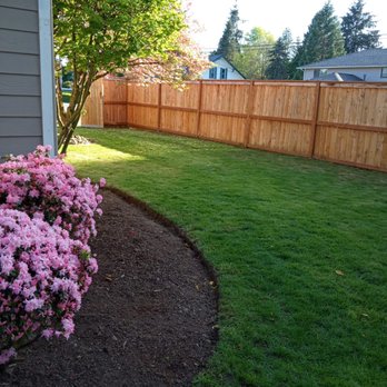 Relva Landscaping and Construction - a flower bed in front of a house - Landscaping Near Me