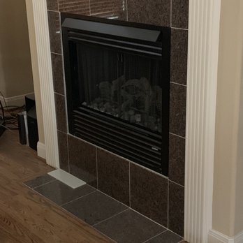 Up To Date Decor - Before picture of fireplace (with sample tile) - General Contractors Near Me