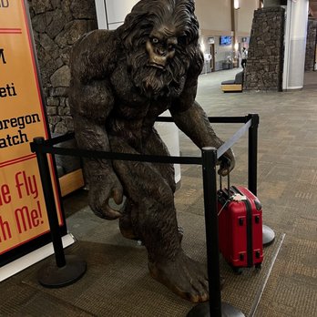 Avalon Aeropub - a statue of a gorilla holding a suitcase - Pubs Near Me - Redmond, Oregon
