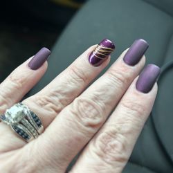 Lavish Nail & Spa - Matte nails with embellishment on ring finger