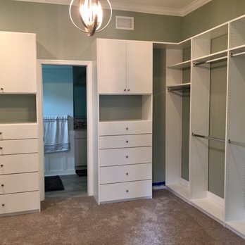 Elevation Home Design - a walk - in closet with white cabinets and drawers - General Contractors Near Me - Tampa, Florida Elevation Home Design - a walk - in closet with white cabinets and drawers - General Contractors Near Me - Tampa, Florida