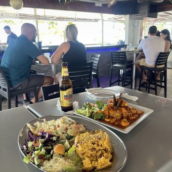 La Parrilla - Grouper filet cooked in garlic butter sauce w/ rice and beans, seafood mofongo w/ creole sauce - Latin American Near Me - Luquillo, Puerto Rico La Parrilla - Grouper filet cooked in garlic butter sauce w/ rice and beans, seafood mofongo w/ creole sauce - Latin American Near Me - Luquillo, Puerto Rico