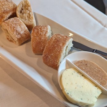 Table 5 - Crusty rolls with 2 butters: shallot, chives, and parsley (savory) and cinnamon (sweet). - New American Near Me - Northville, Michigan Table 5 - Crusty rolls with 2 butters: shallot, chives, and parsley (savory) and cinnamon (sweet). - New American Near Me - Northville, Michigan