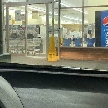 Geely laundromat - This shows how the wet floor sign was used to hold the door open instead of using it inside while mopping was taking place - Laundromat Near Me - Halethorpe, Maryland Geely laundromat - This shows how the wet floor sign was used to hold the door open instead of using it inside while mopping was taking place - Laundromat Near Me - Halethorpe, Maryland
