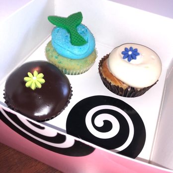 Georgetown Cupcake - Mermaid Vanilla (top left blue cupcake) Blueberry Cheesecake (top right) Chocolate Ganache (bottom) - Cupcakes Near Me - Washington, DC, District of Columbia