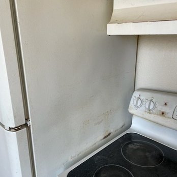 Park 52 - Refrigerator dented scraped and dirty and hood vent dirty - Property Management Near Me - Tacoma, Washington