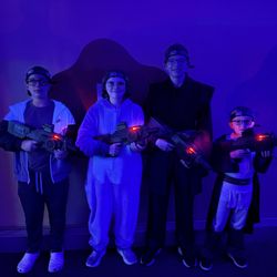 Me 2 You Game Truck - Four players in lit headbands, taggers ready for an indoor round. Mobile laser tag comes to your house across St. Louis and Metro East.