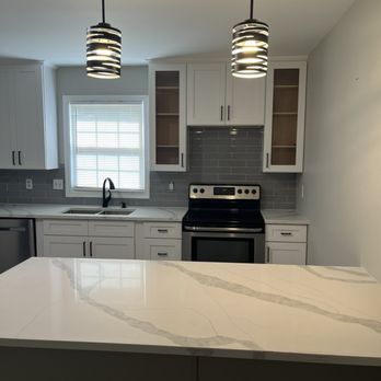 Empire Renovations & Construction - New pendant lights I chose to match my appliances, countertop and cabinets. - General Contractors Near Me