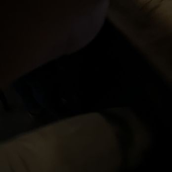 The Corner Pub - My horrible picture of my wings lol - sorry - A low-light, blurry image appears to be taken inside a vehicle, showing a seat and a person's leg, with limited visible details. - Dive Bars Near Me - Boston, Massachusetts
