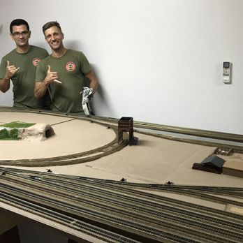 Endless Summer Movers - Endless Summer Movers owner Keith and one of his smart and crew; Cam, posing with my large model railroad layout - 4/5 of it fit the lens! - Movers Near Me Endless Summer Movers - Endless Summer Movers owner Keith and one of his smart and crew; Cam, posing with my large model railroad layout - 4/5 of it fit the lens! - Movers Near Me
