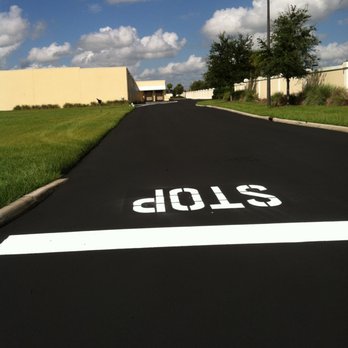 Shields Asphalt Coating - a road with a white line painted on it - General Contractors Near Me - Homosassa, Florida Shields Asphalt Coating - a road with a white line painted on it - General Contractors Near Me - Homosassa, Florida