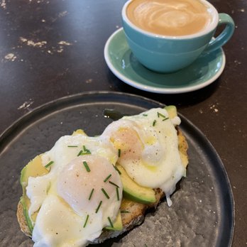 Black Remedy - Cappuccino and Avocado Toast with Poached eggs - Coffee & Tea Near Me - Barcelona, B Black Remedy - Cappuccino and Avocado Toast with Poached eggs - Coffee & Tea Near Me - Barcelona, B