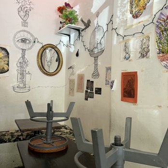 Brooklyn Kava - a table and chairs in a room with drawings on the wall - Coffee & Tea Near Me - Bushwick, New York Brooklyn Kava - a table and chairs in a room with drawings on the wall - Coffee & Tea Near Me - Bushwick, New York