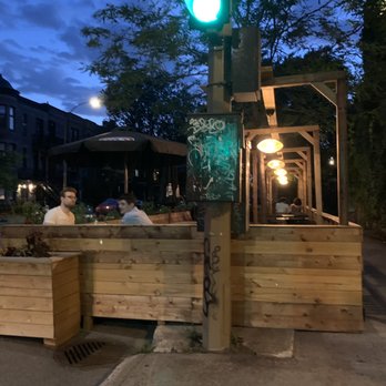 Le MTL Bar - a man sitting at a green light - Bars Near Me - Montreal, Quebec
