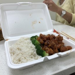 a take out box with rice and broccoli a take out box with rice and broccoli