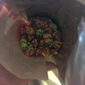 Popped Perfect - a person holding a bag of food - Popcorn Shops Near Me - Fayetteville, Arkansas