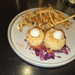 Maryland crab cakes with vinegar slaw and Old Bay seasoned fries