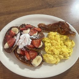 Strawberry and banana French toast with eggs and bacon. This place is delicious and really cozy. Fast and great service! Strawberry and banana French toast with eggs and bacon. This place is delicious and really cozy. Fast and great service!