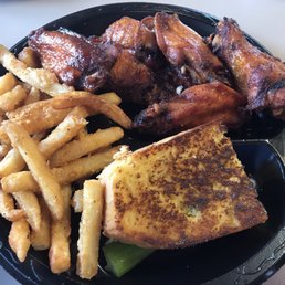 Smoked wings with fries and a slice of cornbread. Banana pudding not shown. Smoked wings with fries and a slice of cornbread. Banana pudding not shown.