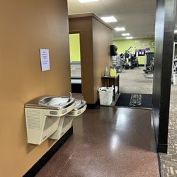 Anytime Fitness - Water fountain and bathroom/tanning bed entrance area