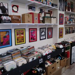 Vinyl Closet Record​s - An entire isle of 45s with .50 cent singles below the rack and boxes of picture sleeves and singles separated by genre on the bottom right.